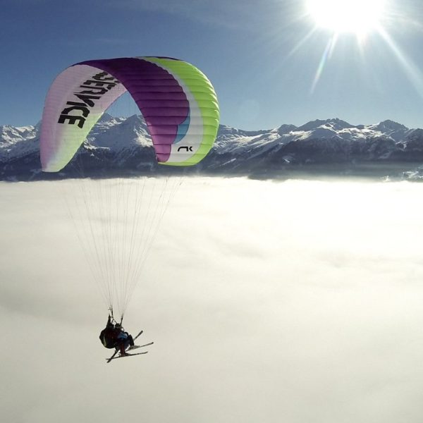 Tandem paragliding above the stratus cloud